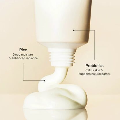 Skincare product with text highlighting rice and probiotics on a beige background