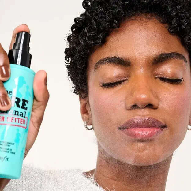 Model using Benefit The POREfessional Super Setter Setting Spray for a smooth, refreshed makeup finish.