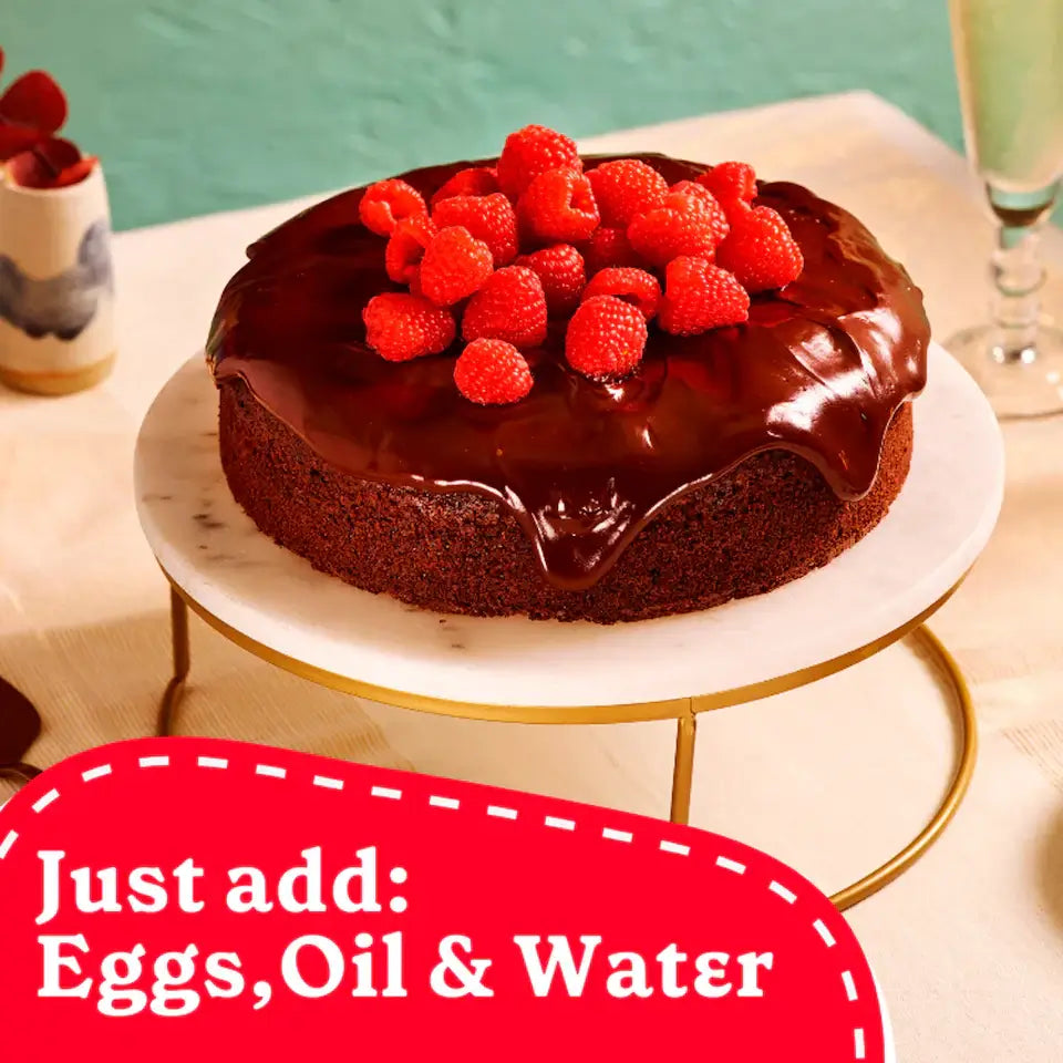 Decadent chocolate cake topped with raspberries, highlighting Betty Crocker Bake Smart Sugar Free Cake Mix, just add eggs, oil, and water.