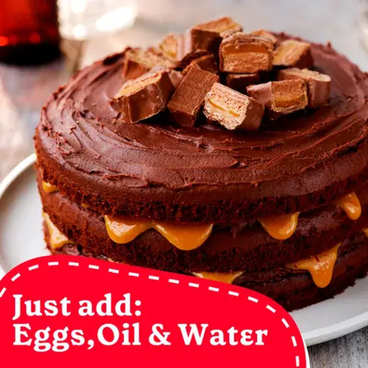 Delicious layered chocolate cake topped with candy, featuring instructions to add eggs, oil, and water.