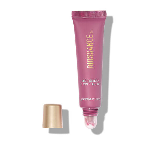 BIOSSANCE Pink lip balm tube with gold cap on a white background