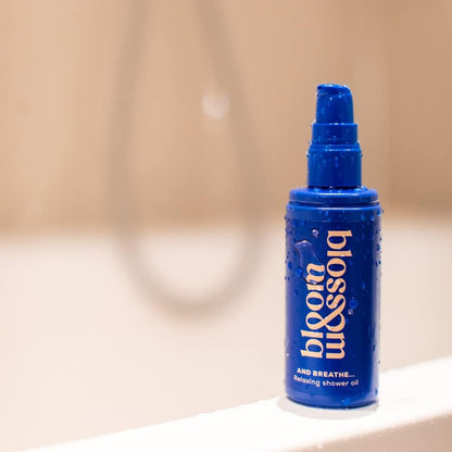 Blue bottle of Bloom & Blossom 'blossom' shower oil on a blurred background
