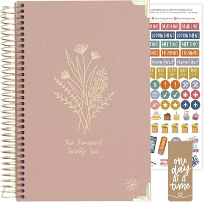 Bloom Daily Planners HARDCOVER 2026 featuring floral design, goal-setting stickers, and motivational reminder.