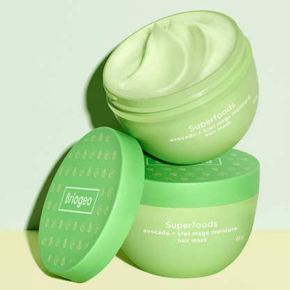 Two green Briogeo hair mask jars with 'Briogeo' branding on a light background