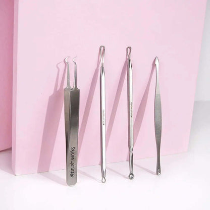 Brushworks Blackhead and Blemish Remover Set featuring four stainless steel skin tools on a pink background.