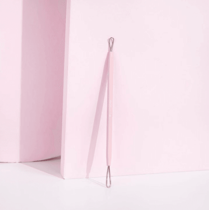 Brushworks Black Head Removal Tool in pink color against a pastel background, designed for clear skin and blackhead removal.