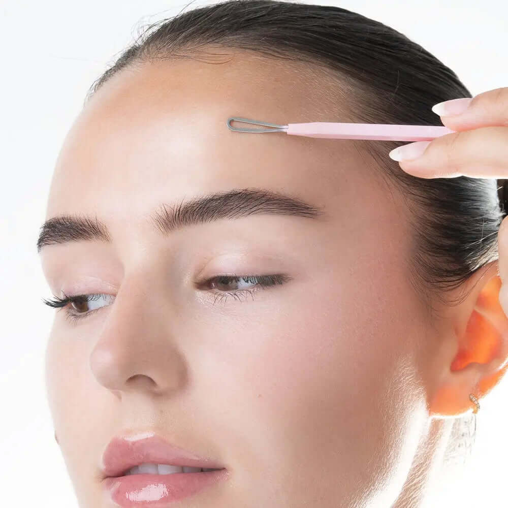 Woman using Brushworks Black Head Removal Tool for clear skin and blemish-free complexion.