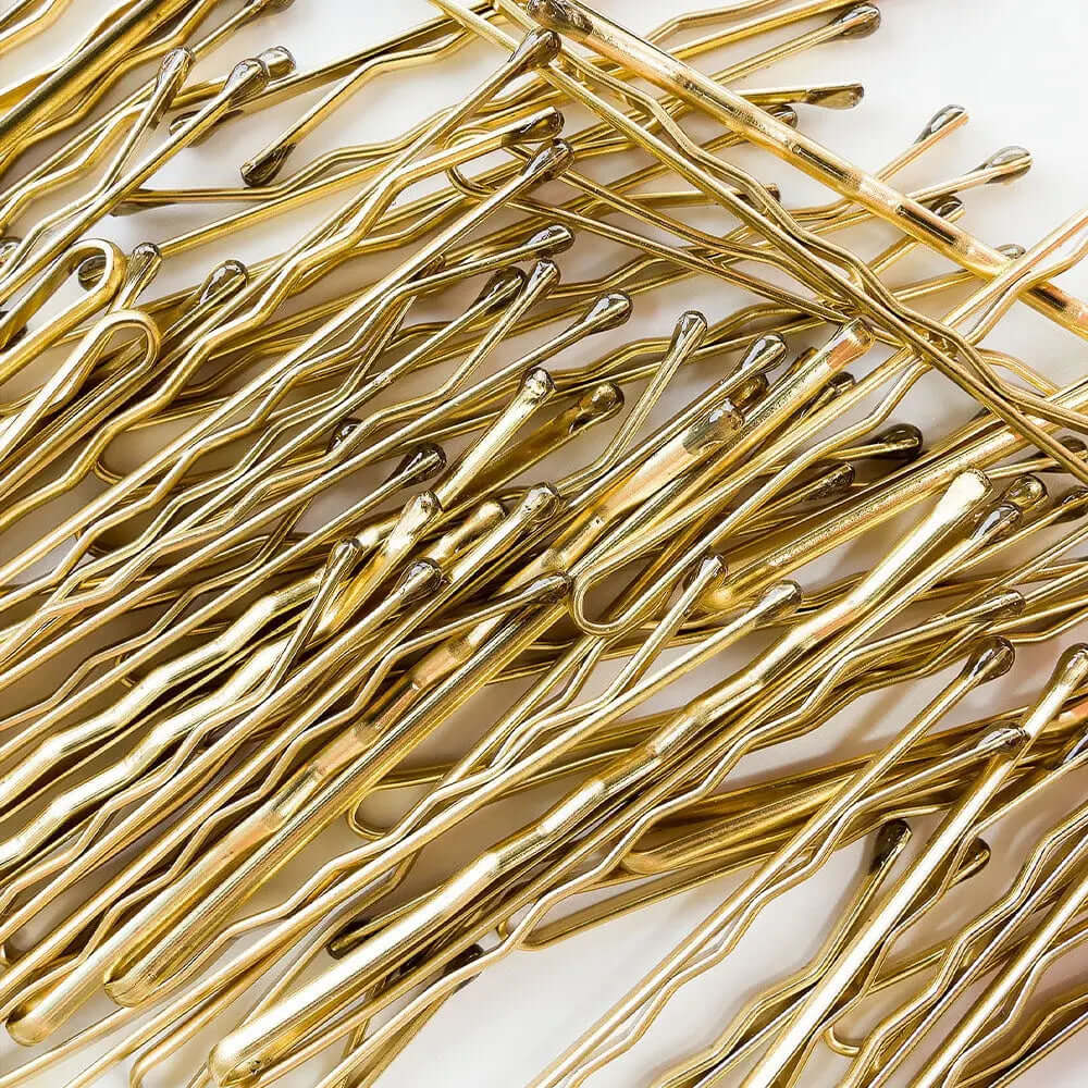 Brushworks blonde bobby pins, ideal for securing blonde or light hair, arranged neatly on a white background.