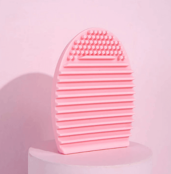 Brushworks Brush Cleaner Tool in pink for deep cleaning makeup brushes, featuring textured surface for effective dirt removal.