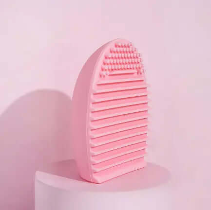 Brushworks Brush Cleaner Tool in pink design with textured surface for effective makeup brush cleaning.