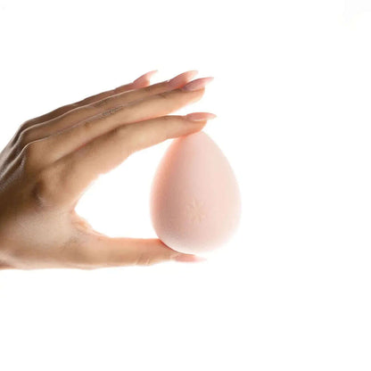 Hand holding Brushworks Complexion Sponge, a hydrophilic makeup sponge for flawless application of liquid and powder products.