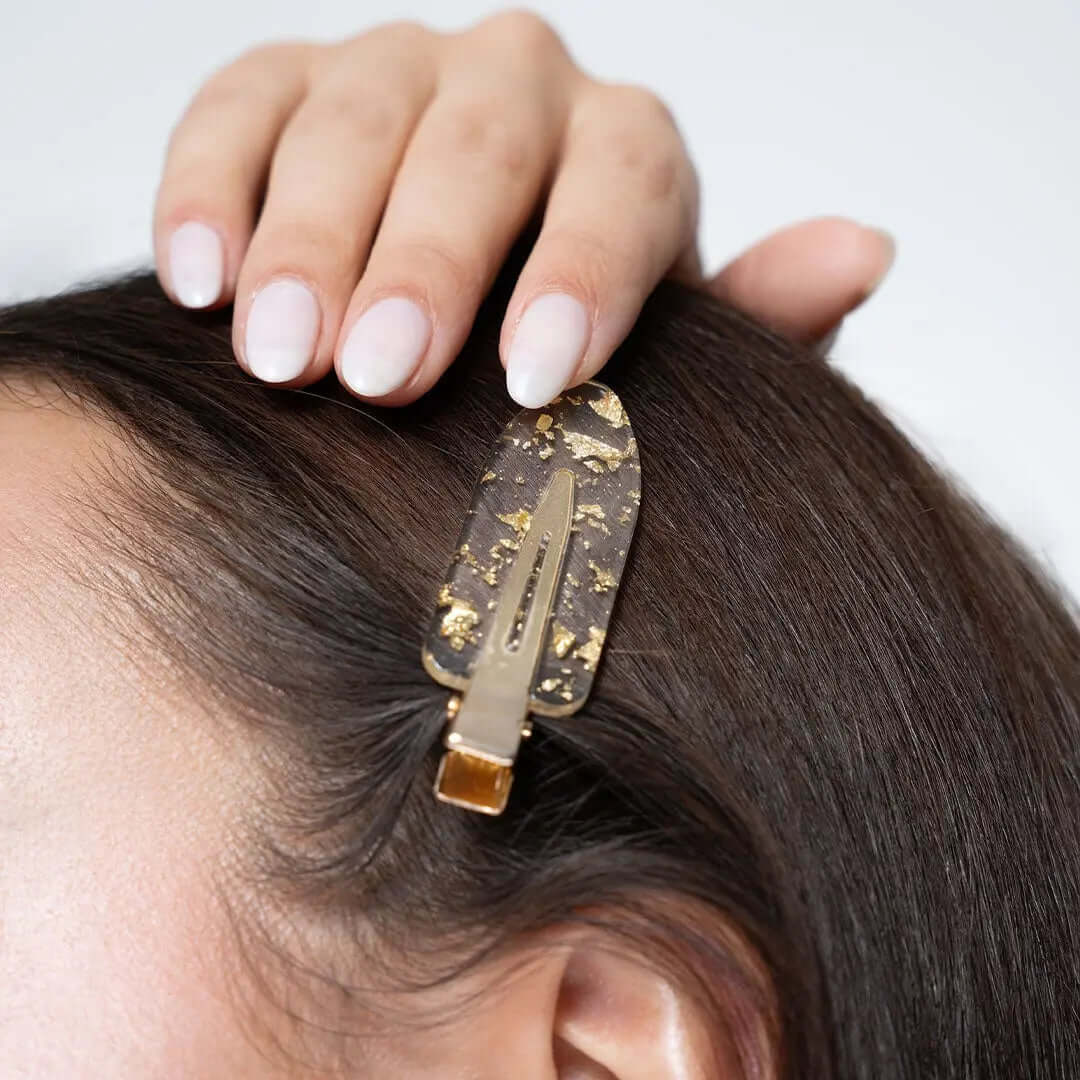 Brushworks Gold Flake No Crease Clip stylishly holding back hair, designed to prevent kinks and suitable for all hair types.