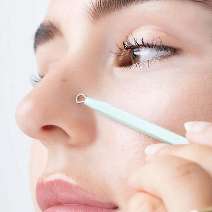 Woman using Brushworks blackhead remover tool on her nose for clear skin and blemish control.