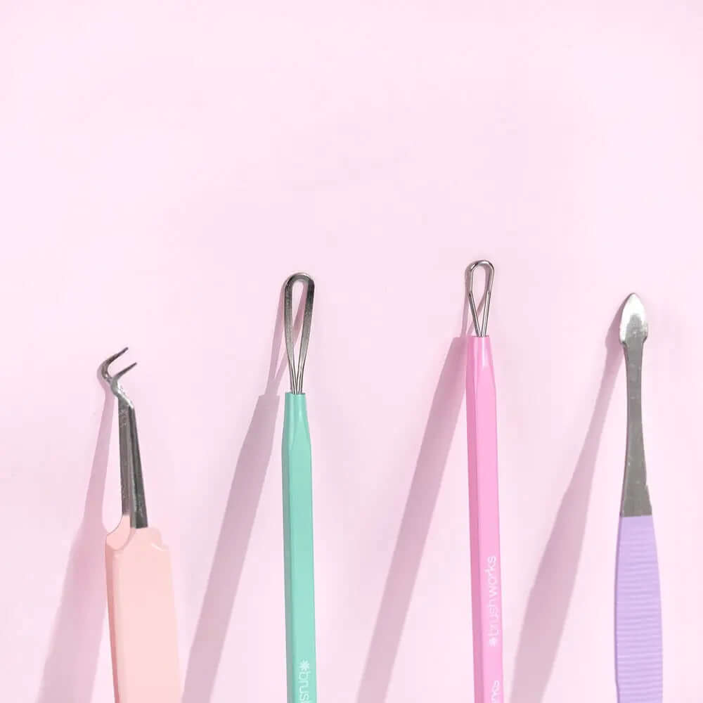 Brushworks HD Blackhead and Blemish Remover Set tools in pastel colors on a pink background, perfect for clear skin.