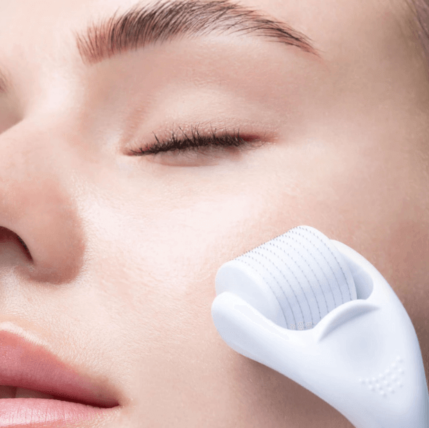 Close-up of a woman using Brushworks HD Micro Needle Derma Roller for smoother, firmer skin.