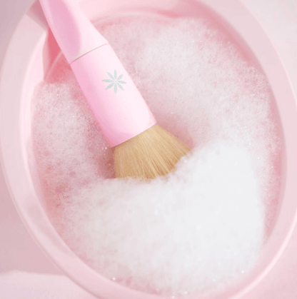 Brushworks silicone makeup brush cleaning bowl with brush in soapy water for effective cleaning.