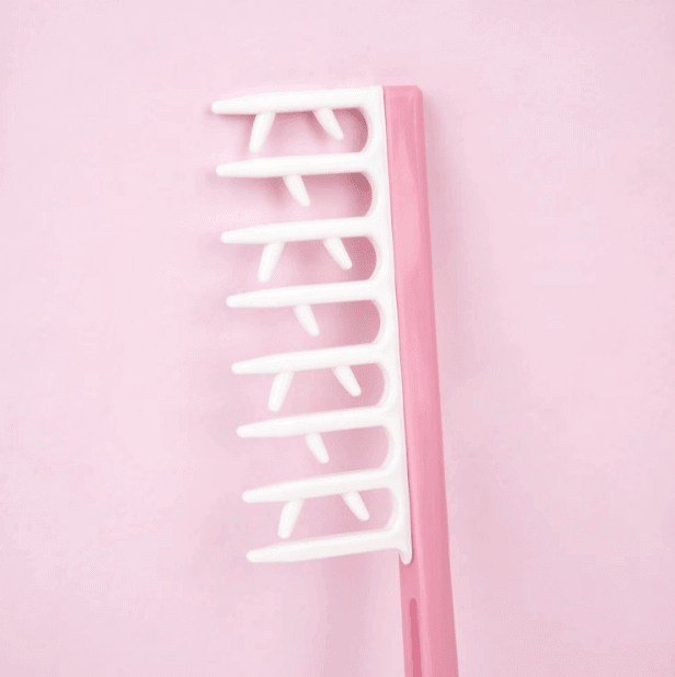 Brushworks Smoothing Curl Comb in pink, designed for smooth curls and easy detangling with extra teeth for separation.