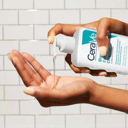 CeraVe Blemish Control Face Cleanser being poured into a hand against a tiled background.