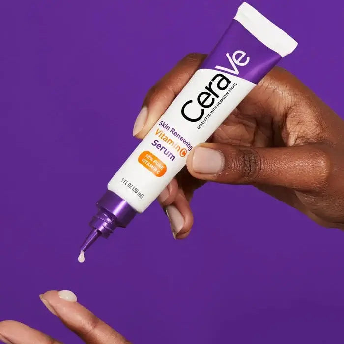 CeraVe serum tube being applied to a hand against a purple background