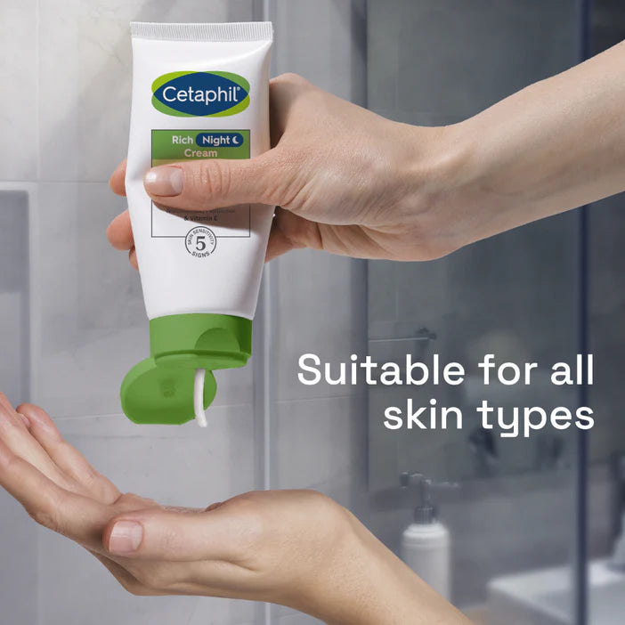 Cetaphil tube being held above a hand with a bathroom background