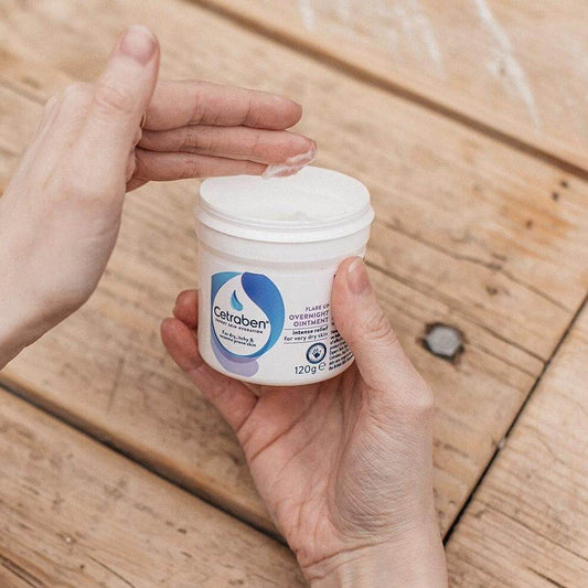 Person applying Cetraben Ointment, hydrating dry and eczema prone skin from a 120g container.