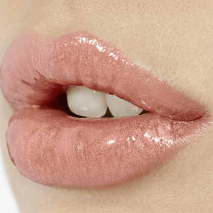 Glossy lips enhanced by Charlotte Tilbury Lip Lustre in Pillow Talk, showcasing a creamy, non-sticky nude-pink finish.