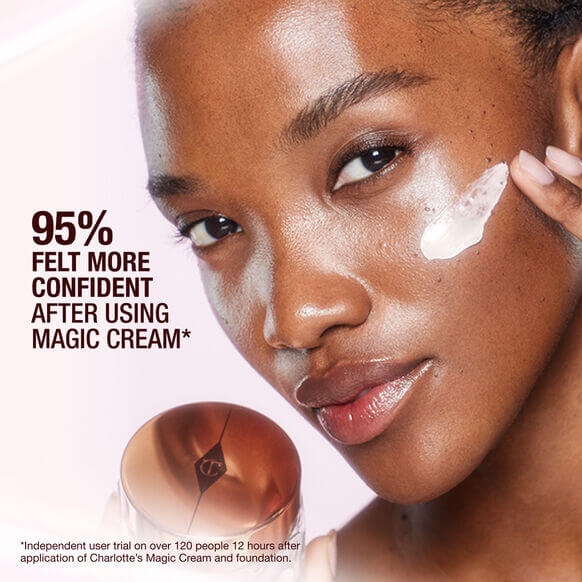 Close-up of a woman applying Charlotte's Magic Cream, showcasing radiant skin a Charlotte Tilburynd hydration benefits.
