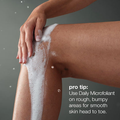 Person applying a foamy Dermalogica product to their leg with a gray background
