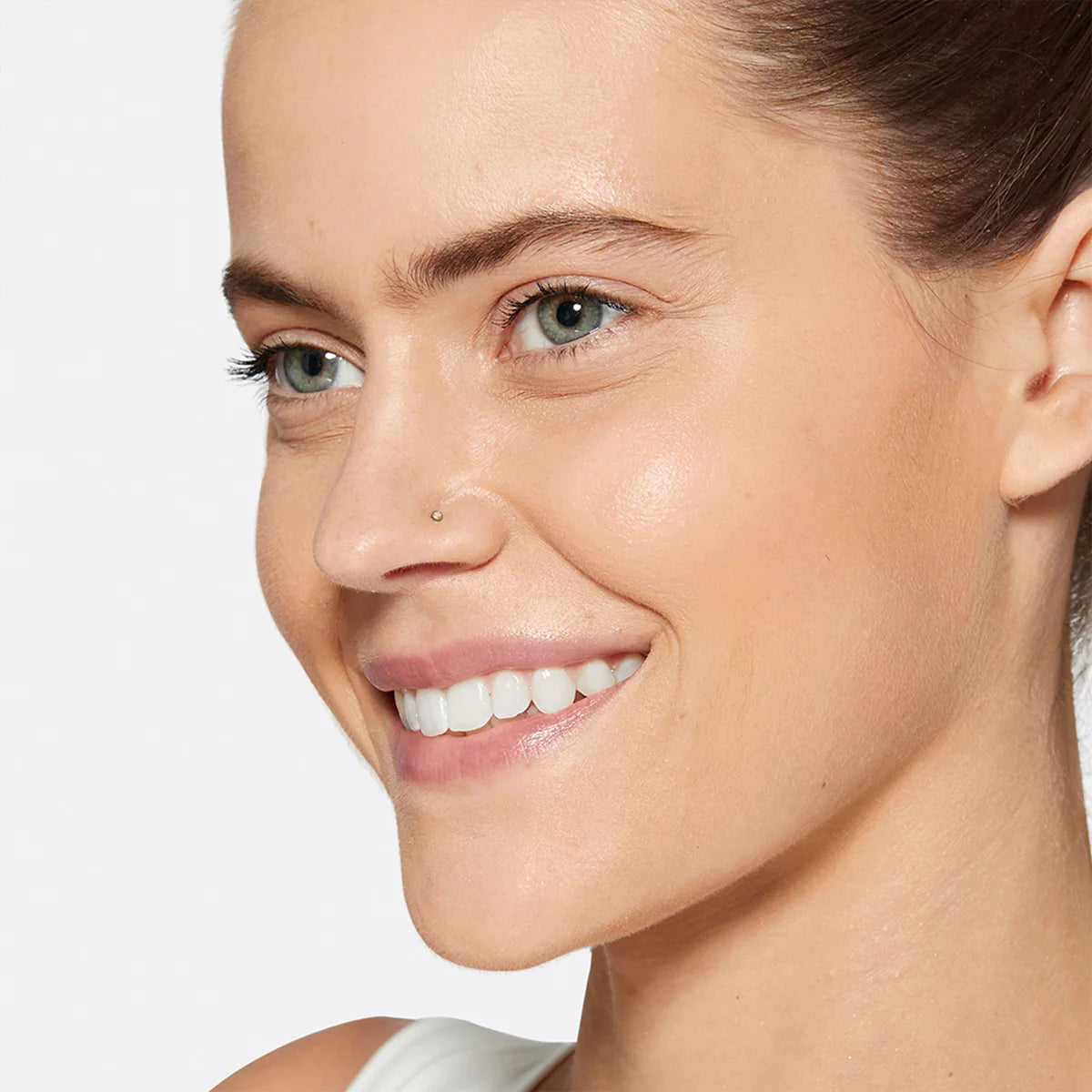 Close-up of a woman's face with a dermalogica neutral background