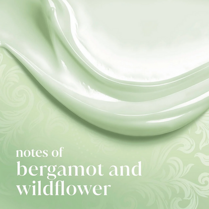 Close-up of a green ceramic plate with swirling patterns on a matching green background, featuring text Dove 'notes of bergamot and wildflower'.