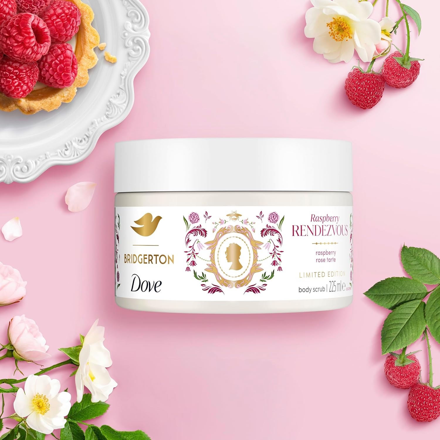 Bridgerton Dove raspberry body scrub jar on a pink background with raspberries and flowers