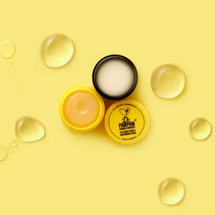 Dr. PawPaw lip balm and cream on a yellow background with clear droplets.