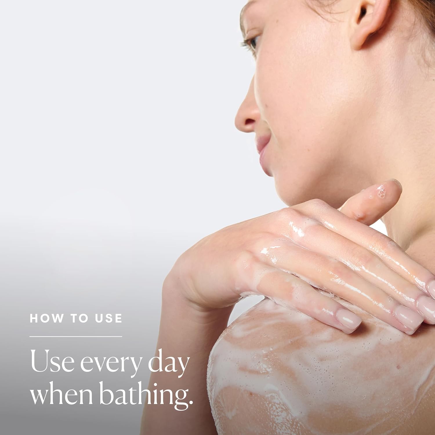 Woman applying a skincare product on her arm with a neutral background