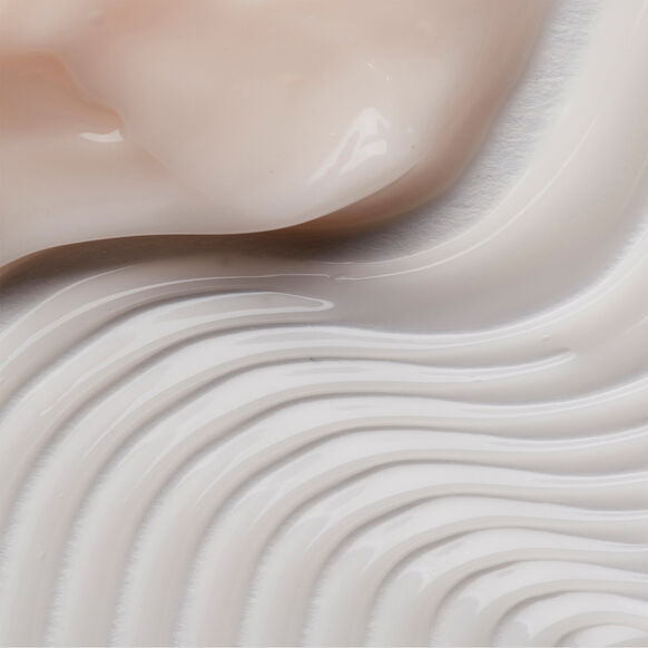 Close-up of smooth, flowing beige and white liquid ELEMIS texture