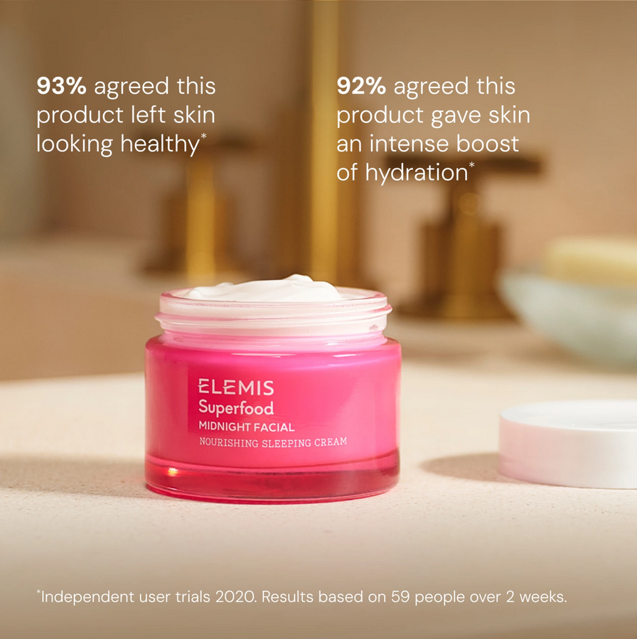 Pink jar of ELEMIS Superfood Midnight Facial Nourishing Sleeping Cream on a blurred bathroom background