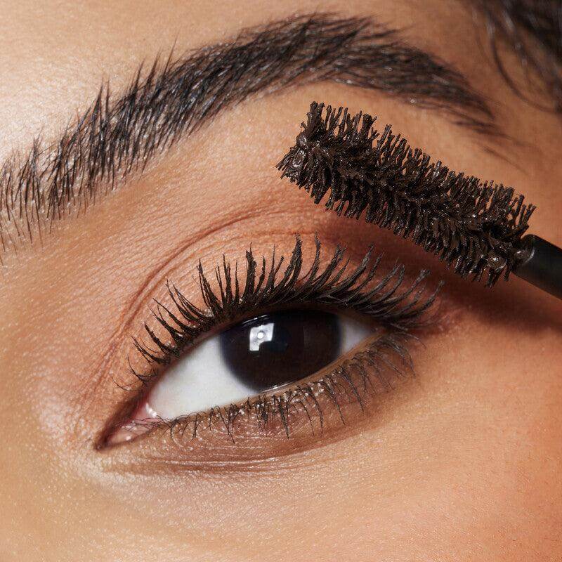 Close-up of eye applying e.l.f Big Mood Mascara for bold, defined lashes with an hourglass-shaped brush.