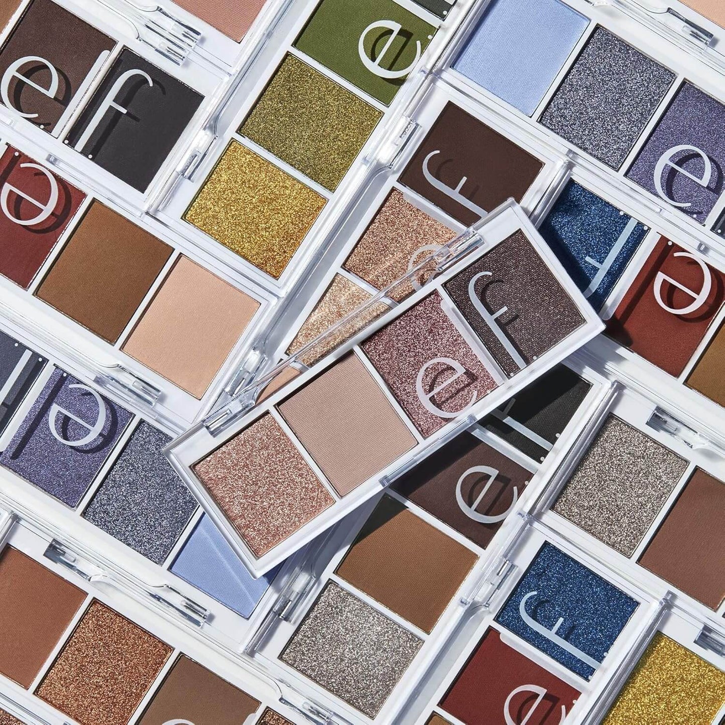 Multiple open eyeshadow palettes from the brand 'e.l.f.' showing a variety of colors.