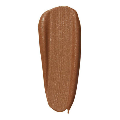 Swatch of e.l.f Halo Glow Liquid Filter in a warm bronze shade, showcasing its luminous finish and smooth texture.