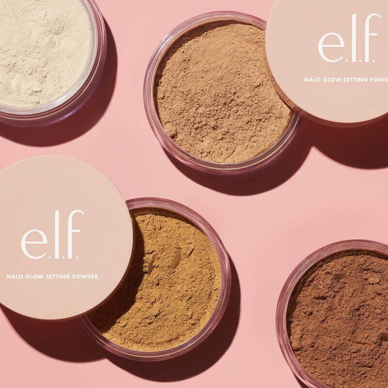 e.l.f Halo Glow Setting Powder jars showcasing assorted shades on a pink background for a radiant finish.