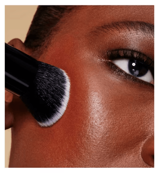 e.l.f. Makeup brush applying powder to a person's face