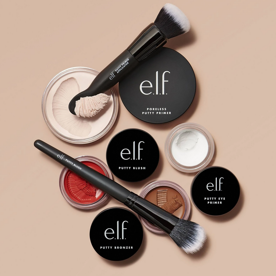 e.l.f Putty Bronzer, Putty Blush, and Putty Eye Primer with brush on a beige background.