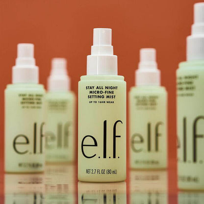 e.l.f Stay All Night Micro-Fine Setting Mist in front of other bottles, lightweight spray for 16 hours of makeup wear.