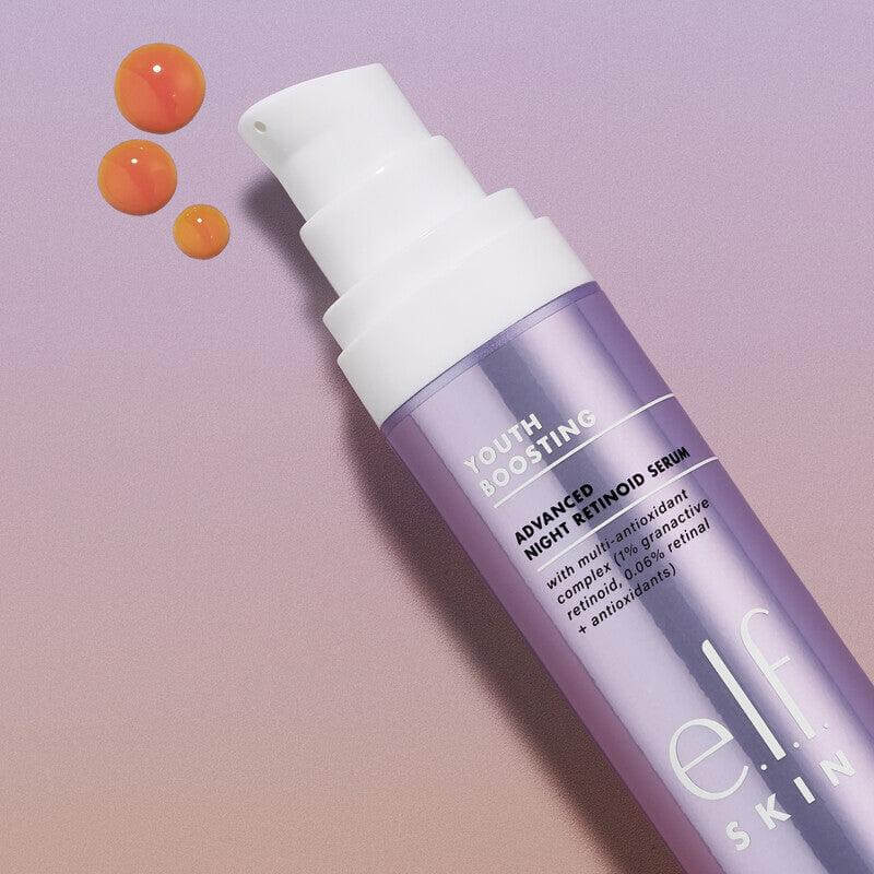 e.l.f Youth Boosting Advanced Night Retinoid Serum 29.5ml bottle with serum drops, enhances skin radiance and reduces wrinkles.
