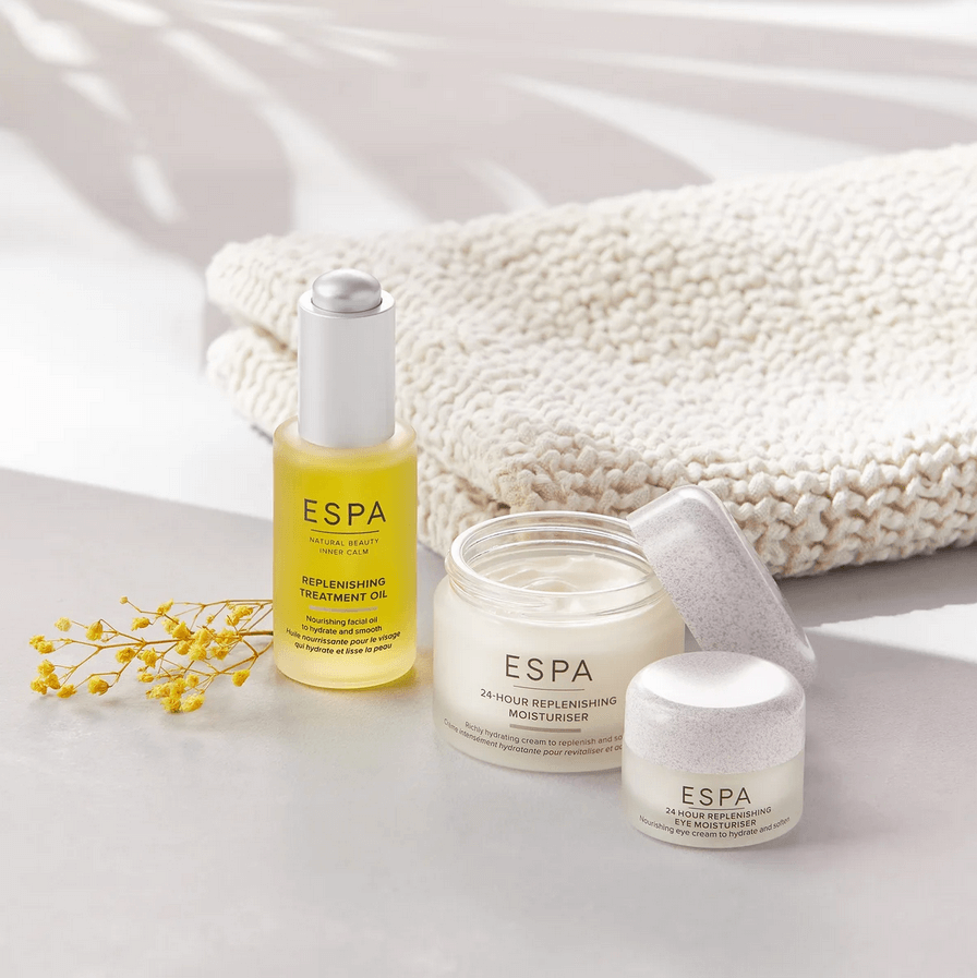 Espa skincare products on a light surface with a textured white towel in the background