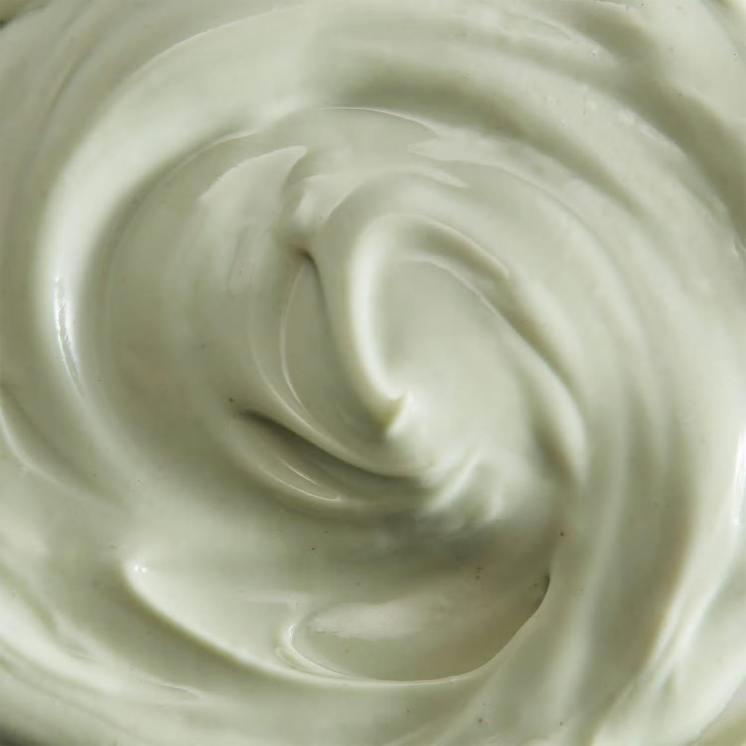 Close-up of a swirl of ESPA  light green cream or frosting