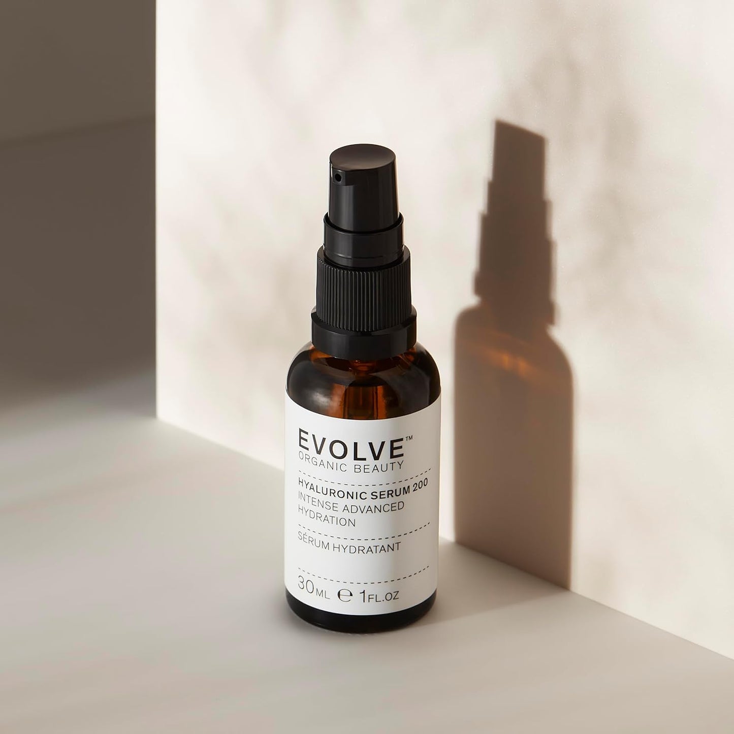 Evolve serum bottle on a neutral background