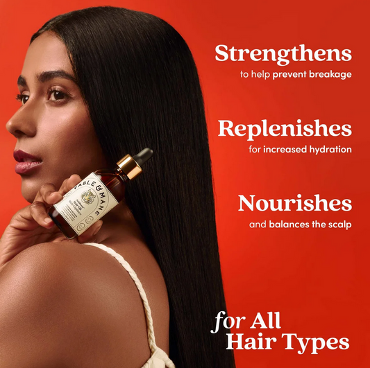 Woman holding a bottle of Fable & Mane hair oil with text on a red background
