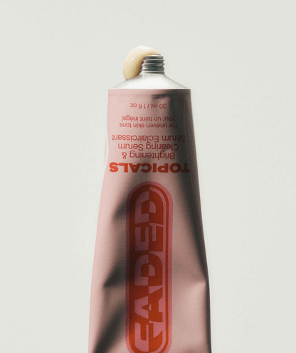 Faded Brightening + Clearing Serum For Dark Spots + Uneven Skintone in a pink tube with vibrant branding.