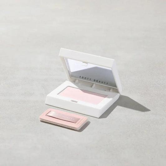 Fenty Beauty Mini Invisimatte Instant Setting + Blotting Powder in sleek white compact, featuring a lightweight, talc-free formula.