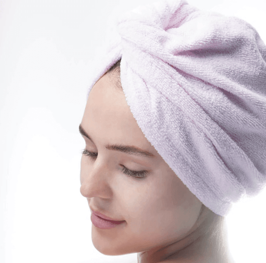 Woman wearing a Brushworks Hair Wrap microfibre towel, showcasing moisture-wicking and heat protection features.